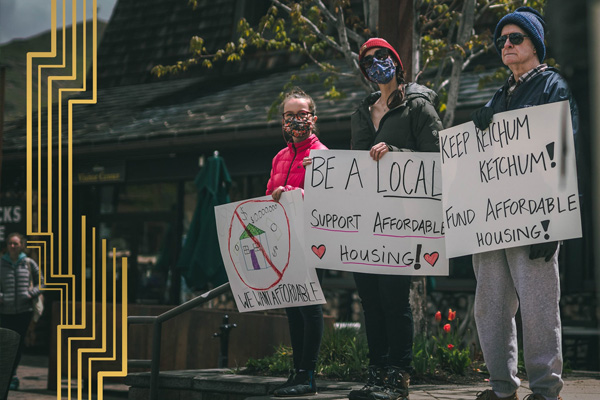 Activists holding up hand-made signs in support of affordable housing. Photo Illustration by The Daily Beast / Photo Courtesy Brad Womack