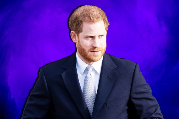 Prince Harry dressed in a navy suit looking off into the distance. Photo Illustration by Thomas Levinson/The Daily Beast/Getty