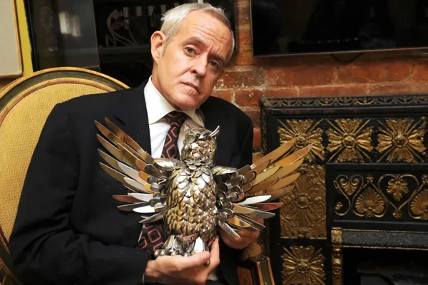 Former 'Congregation for the Light' member Paul Arthur Miller holding a metal owel sculpture with it's wings outstretched. Photo credit Helayne Seidman